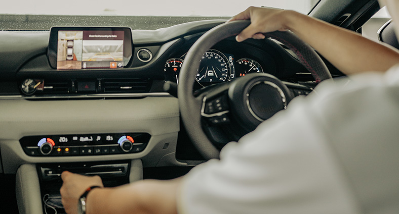 An image of a valet in a vehicle, with a high-tech dashboard displaying various information.