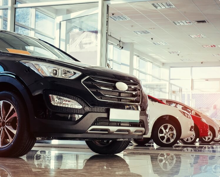 A row of cars in a showroom.